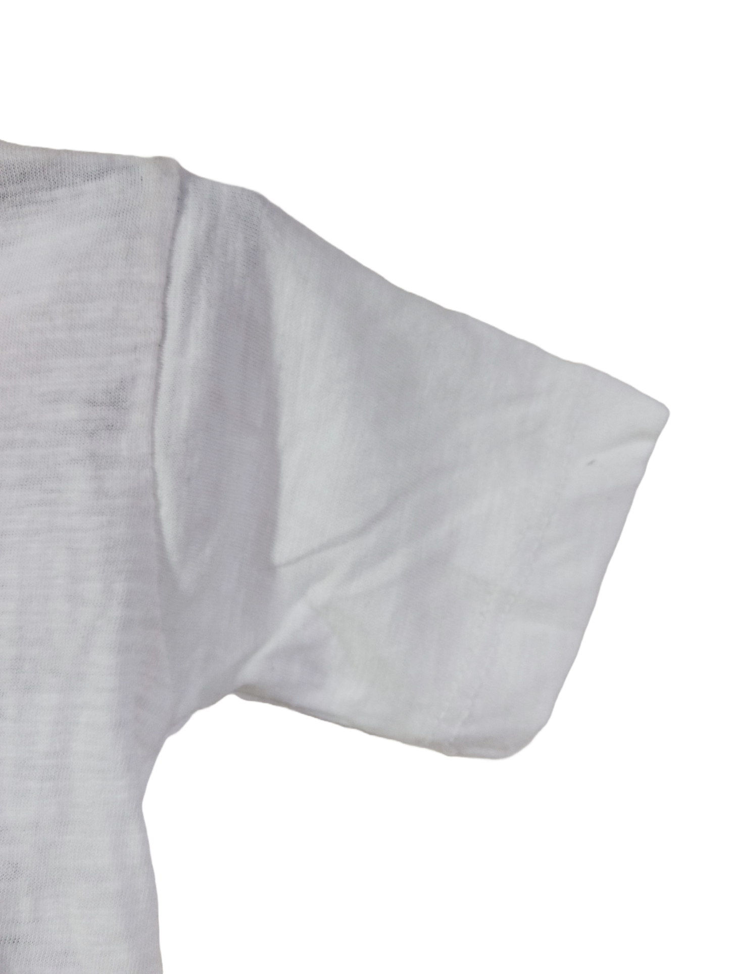 White t-shirt sleeve against black background.